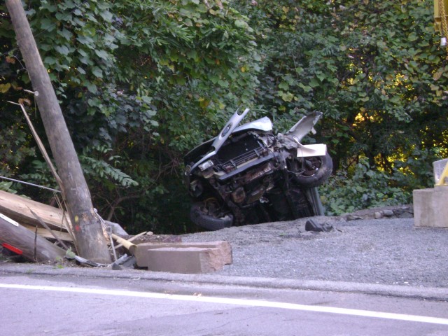 Serious MVA On Oregon Rd With Car Over Wall After Taking Down 2 Utility Poles