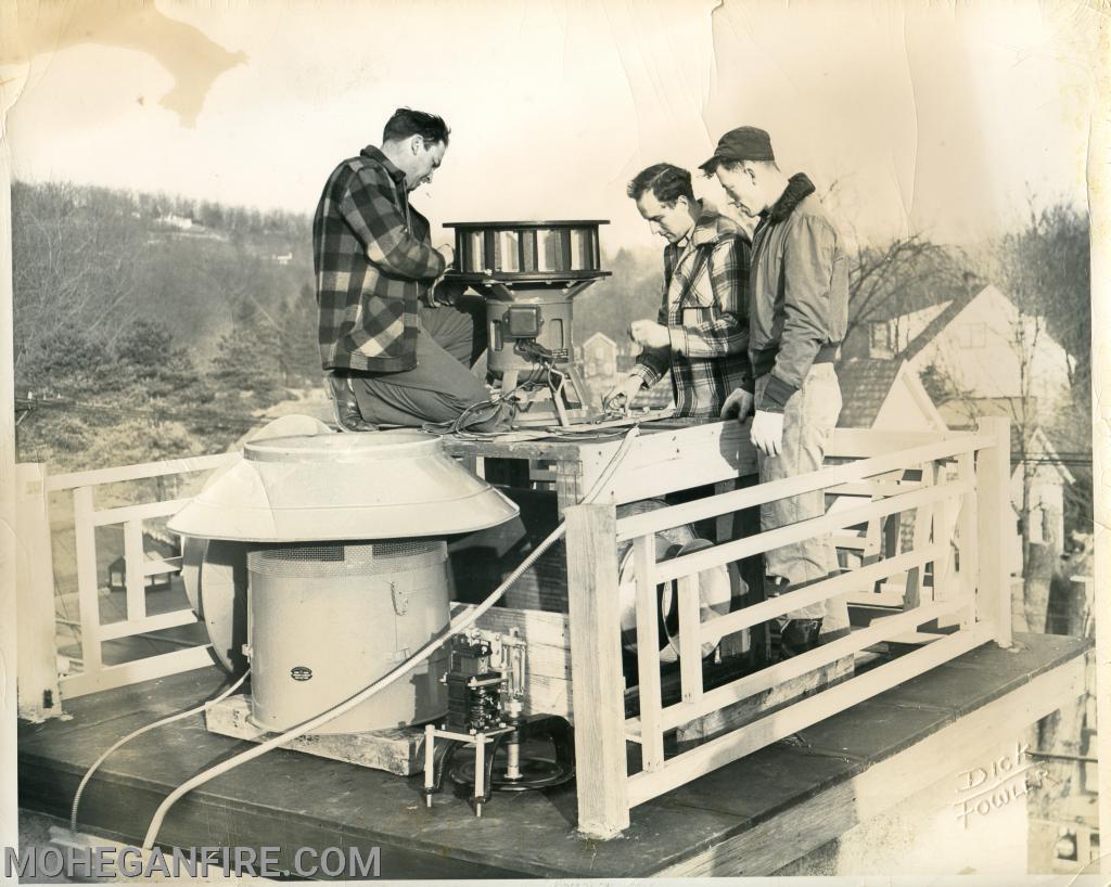 Installing a siren on the roof of Fire Headquarters